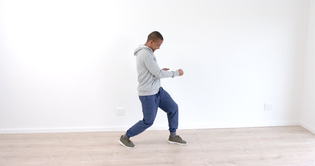 Man Dancing Vibrantly in Minimalist Studio Environment