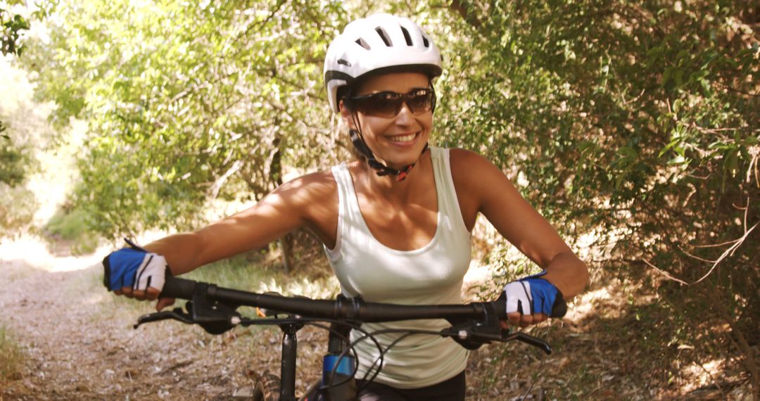 Happy Woman Cycling Through Forest Trail in Summer - Free Images, Stock Photos and Pictures on Pikwizard.com