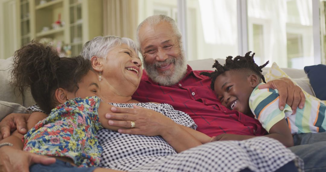 Joyful African American Family Hugging Together on Couch - Free Images, Stock Photos and Pictures on Pikwizard.com