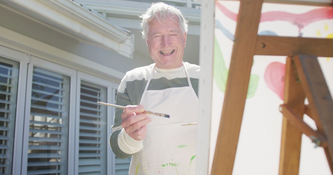 Senior Man Painting Canvas Outdoors on Sunny Day - Free Images, Stock Photos and Pictures on Pikwizard.com