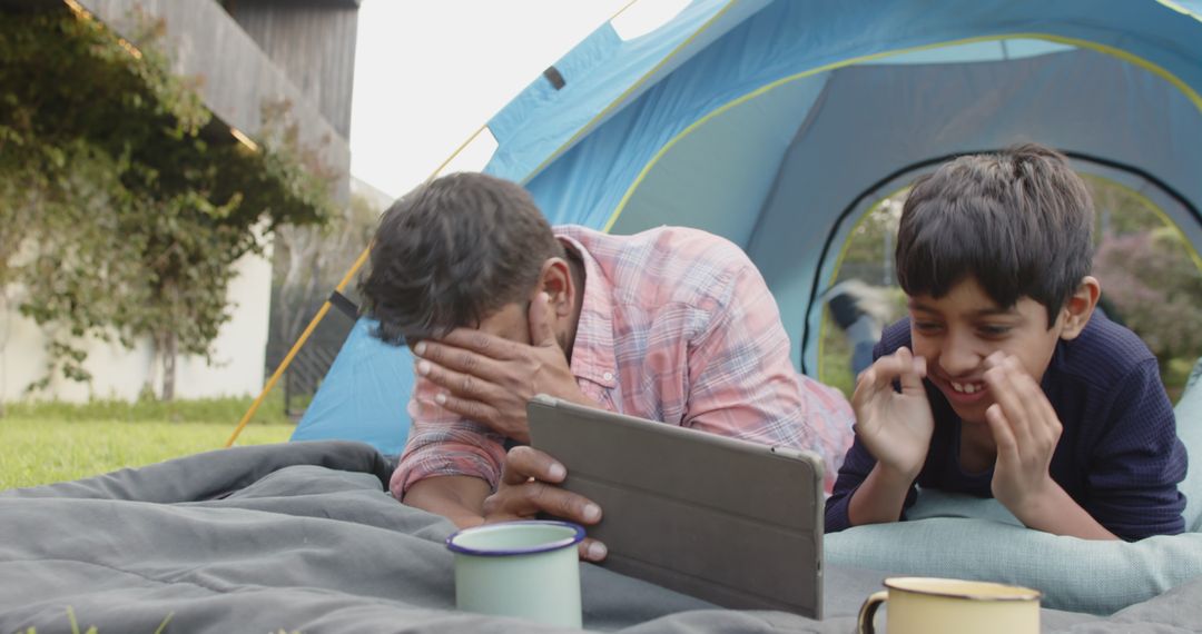 Father and Son Enjoying Outdoor Leisure Time with Tablet