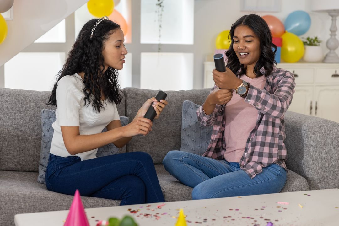 Friends Exploring Smart Devices at Home Celebration