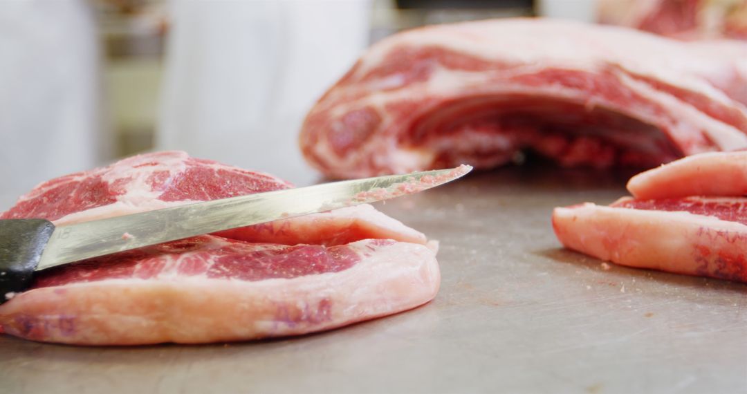 Butcher Slicing Raw Meat on Stainless Steel Table - Free Images, Stock Photos and Pictures on Pikwizard.com