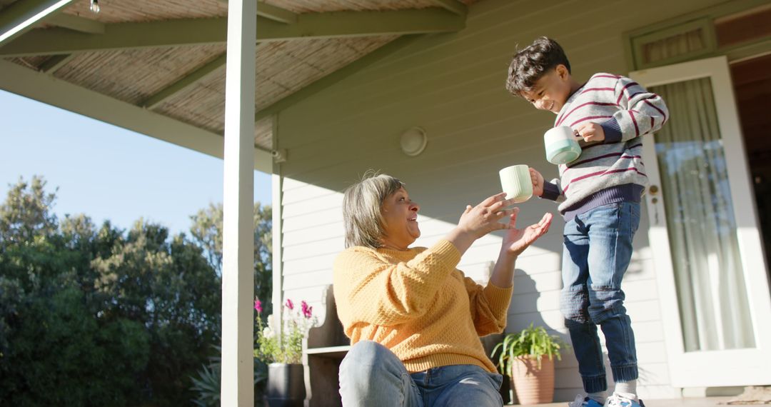 Grandmother and Grandson Enjoying Tea on Porch - Free Images, Stock Photos and Pictures on Pikwizard.com