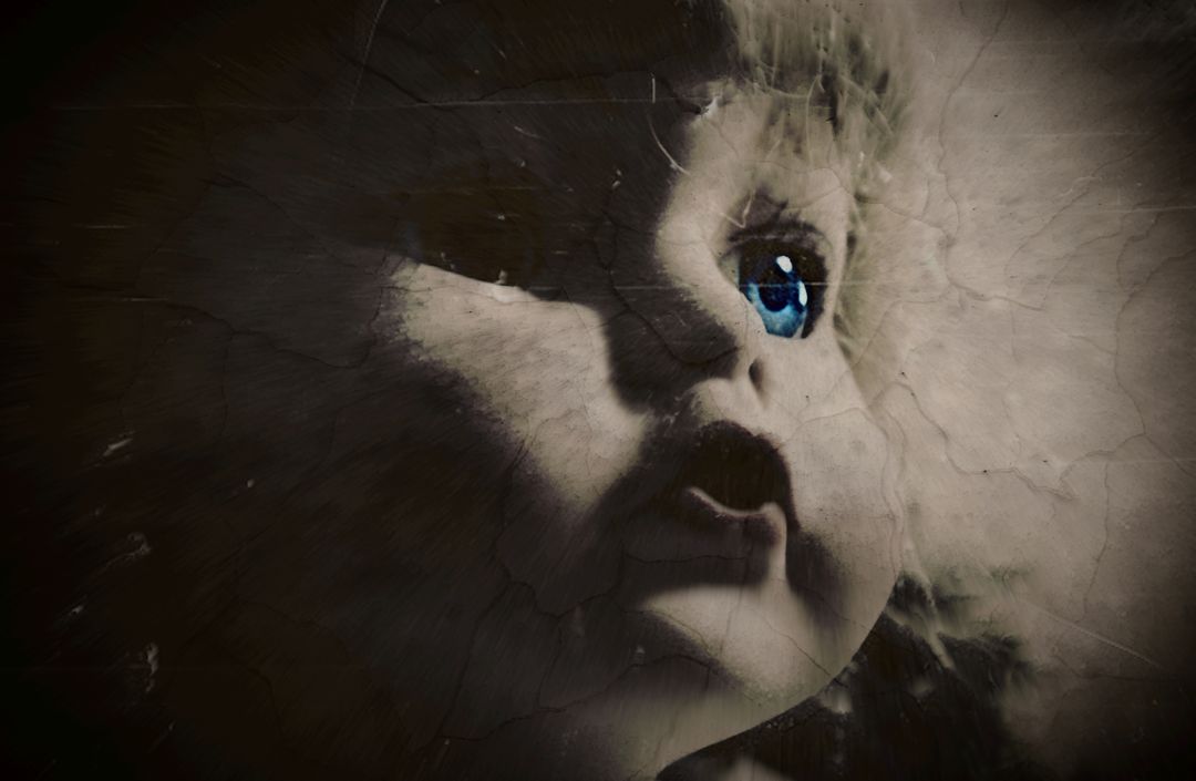 Close-Up of Creepy Cracked Doll with Blue Eye in Dark Lighting