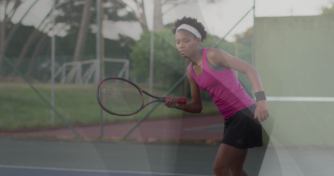 Focused Tennis Player Preparing for Return on Court