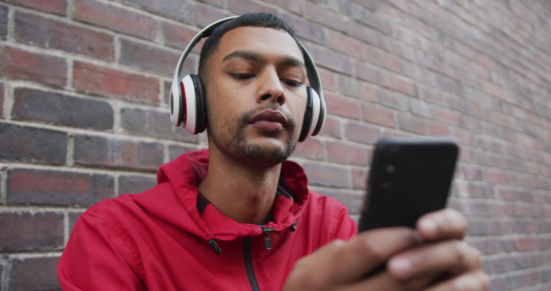 Man Listening to Music on Smartphone Outdoors