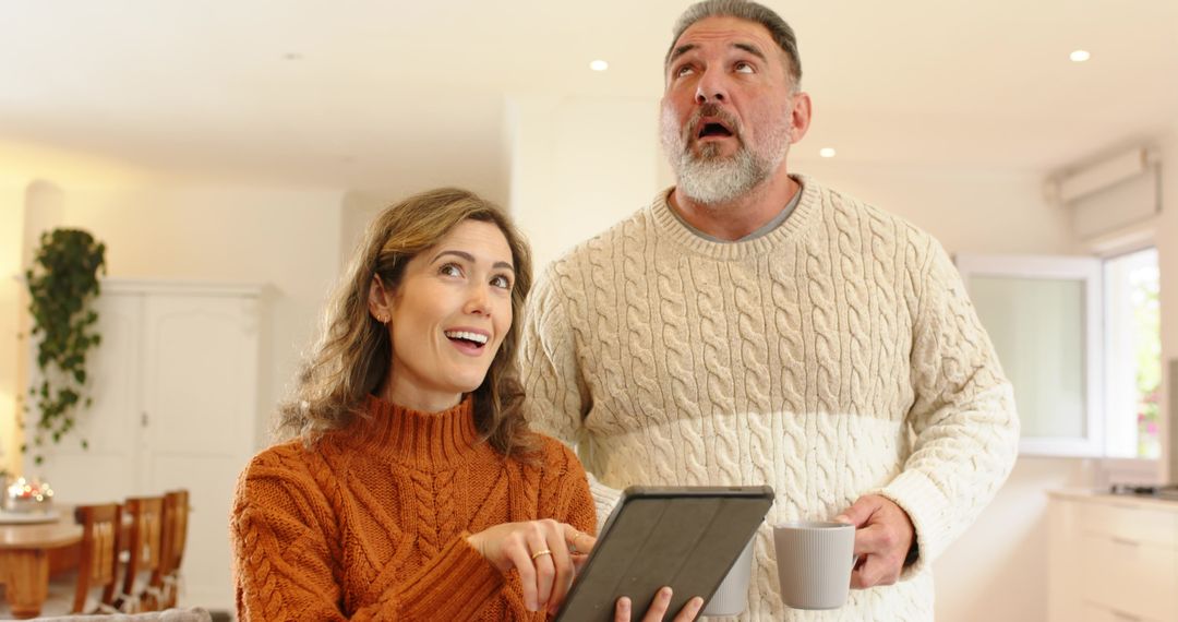 Couple Enjoying Cozy Morning in Bright Minimalist Kitchen Using Tablet
