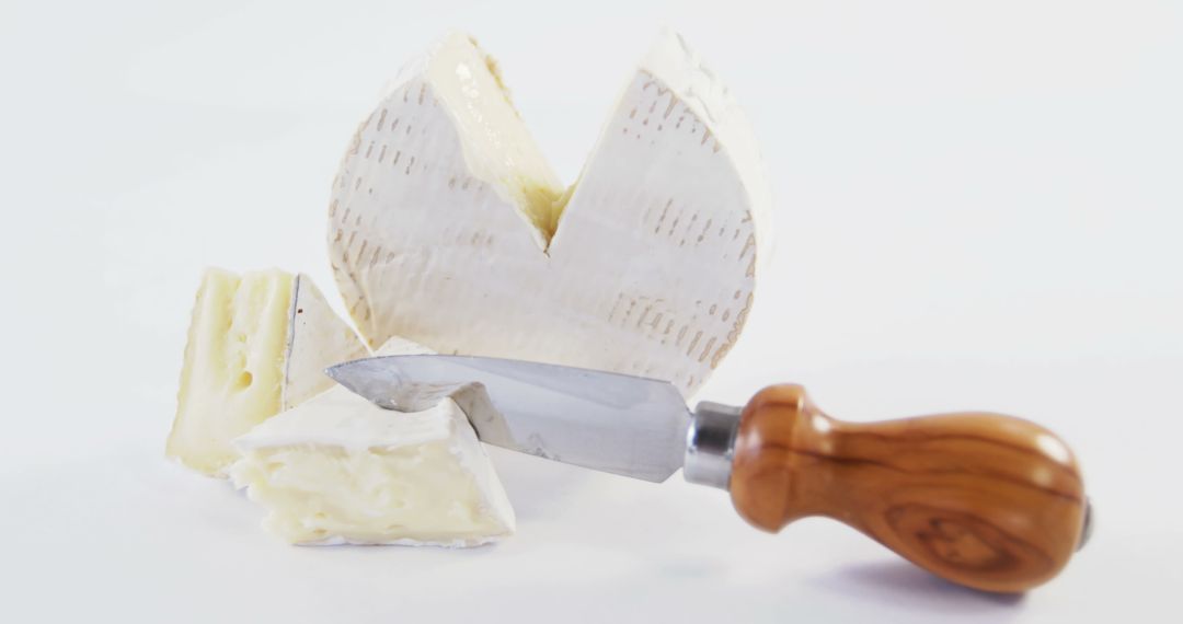 Sliced Brie Cheese with Wooden Handle Knife on White Background - Free Images, Stock Photos and Pictures on Pikwizard.com