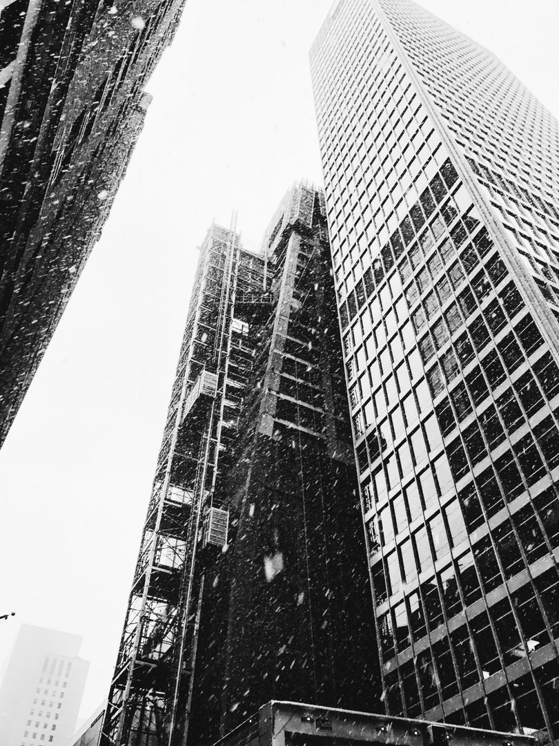 Snow Falling on Skyscrapers in Urban Downtown - Free Images, Stock Photos and Pictures on Pikwizard.com