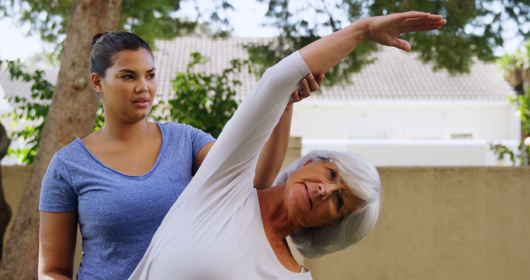 Senior woman doing stretching exercise with physical therapist outdoors - Free Images, Stock Photos and Pictures on Pikwizard.com