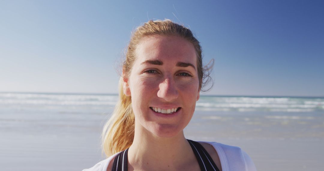 Smiling Woman on Sunny Seaside Beach - Free Images, Stock Photos and Pictures on Pikwizard.com