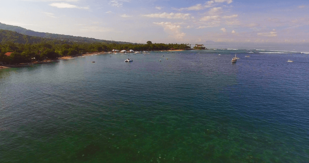 Transparent Blue Sea Under Open Sky Scenic Coastal View