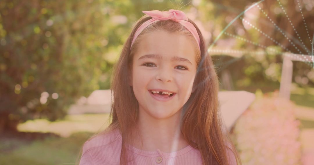 Cheerful Girl Streaming Confidence in Sunny Backyard with Lens Flare