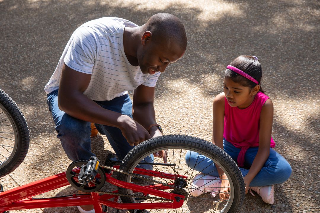 Father and Daughter Exploring Bicycle on Sunny Path