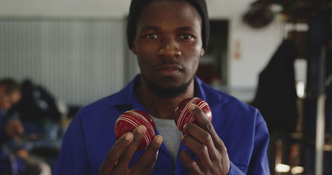 Young African American Man Holding Cricket Balls Indoors - Free Images, Stock Photos and Pictures on Pikwizard.com