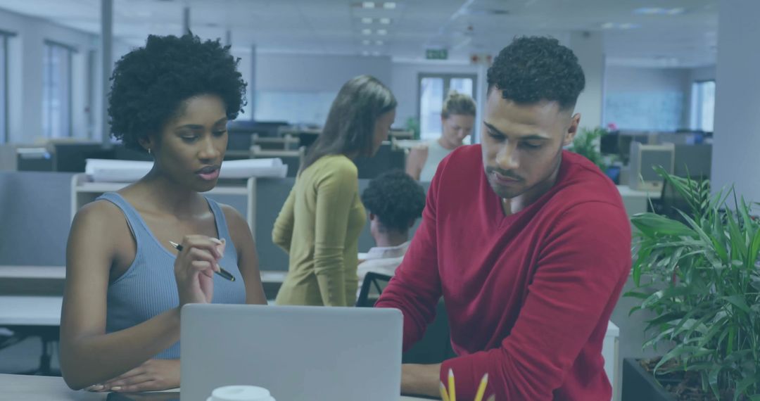 Collaborative Colleagues Discussing Project in Open-Plan Office