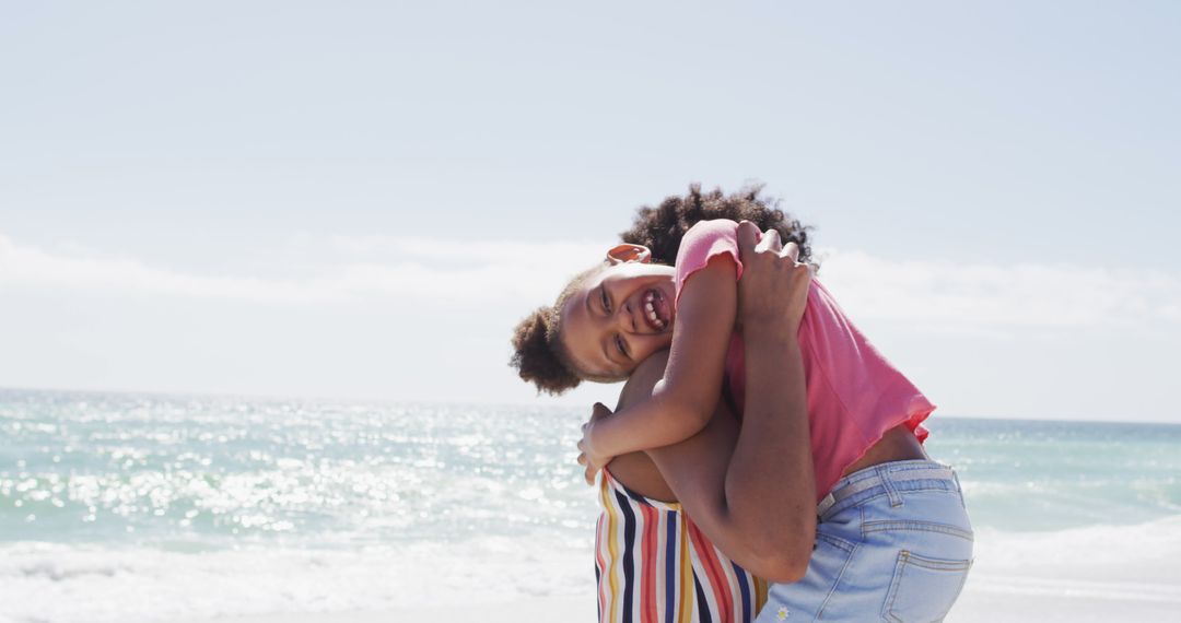 Joyful Afro-American Parent and Child Hugging at the Beach - Free Images, Stock Photos and Pictures on Pikwizard.com