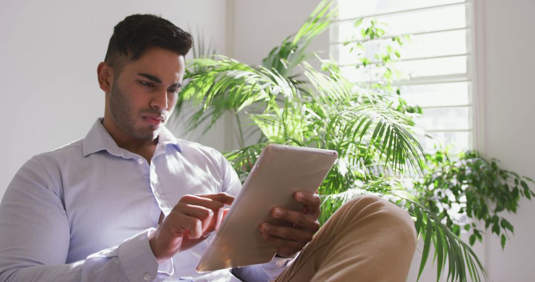 Professional Man Using Tablet in Bright Office Environment