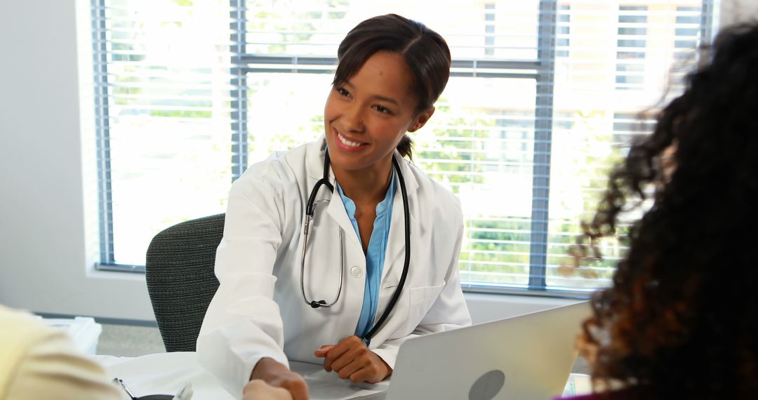 Friendly African American Doctor Greeting Happy Patient in Office - Free Images, Stock Photos and Pictures on Pikwizard.com