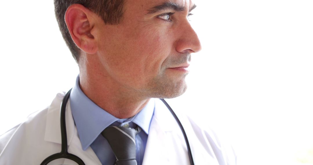 Professional Doctor in Thoughtful Pose Highlighting Dedication - Free Images, Stock Photos and Pictures on Pikwizard.com