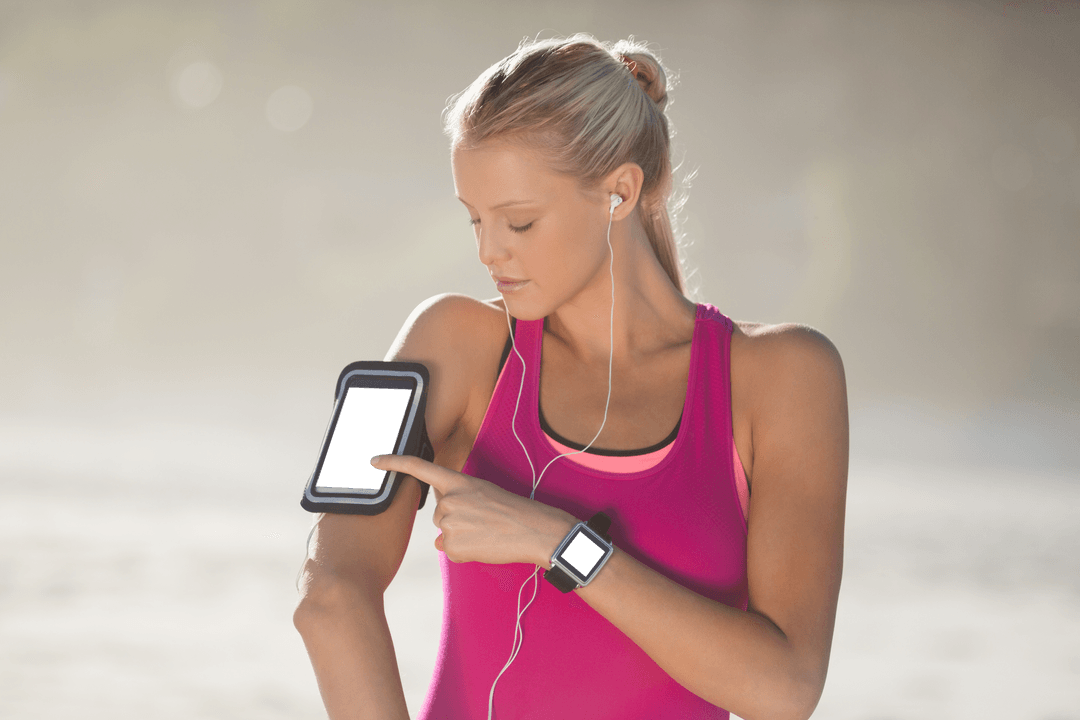 Focused Woman Using Fitness Tracker and Transparent Arm Band Smartphone