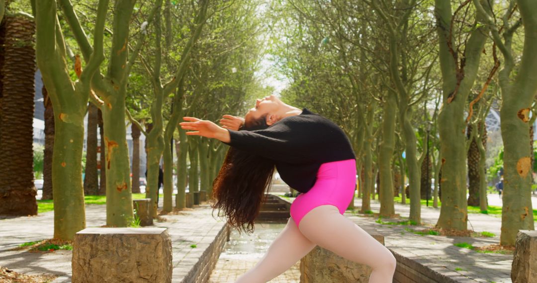 Graceful Dancer Stretching in Lush Park - Free Images, Stock Photos and Pictures on Pikwizard.com