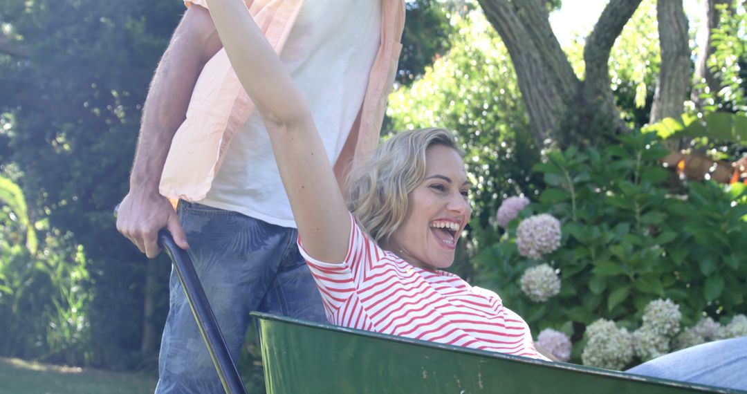 Couple Enjoying Playful Moment in Sunny Garden
