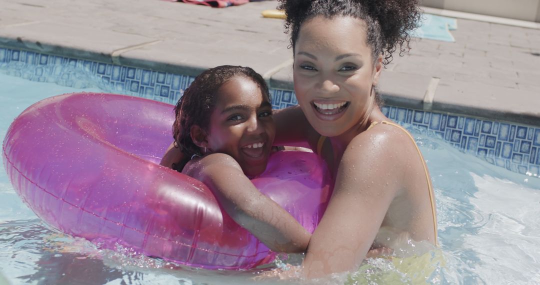 Mother and Daughter Enjoying a Summer Pool Day Together - Free Images, Stock Photos and Pictures on Pikwizard.com