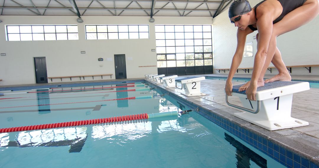 Athlete Preparing to Dive at Indoor Pool in Slow Motion