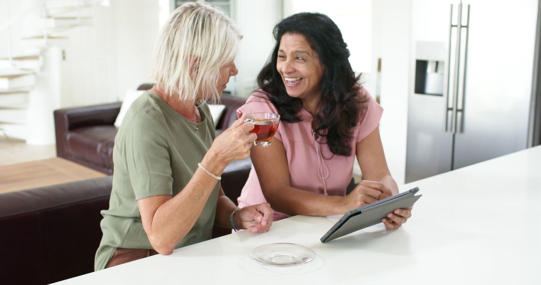 Two Mature Women Socializing at Home While Drinking Tea - Free Images, Stock Photos and Pictures on Pikwizard.com