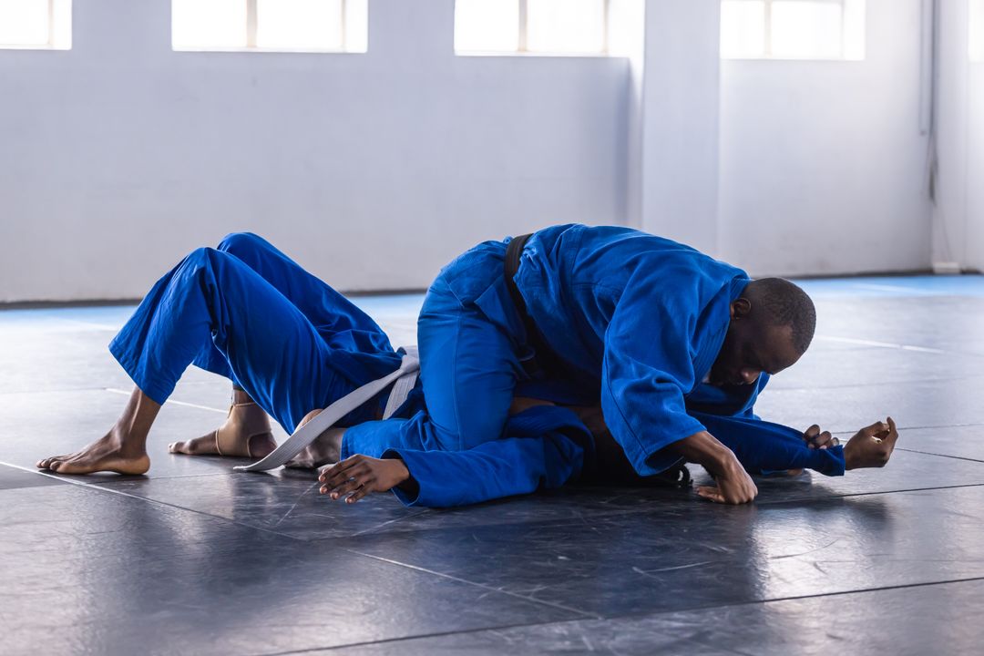 Two Martial Artists Grappling in Gym Practicing Skills