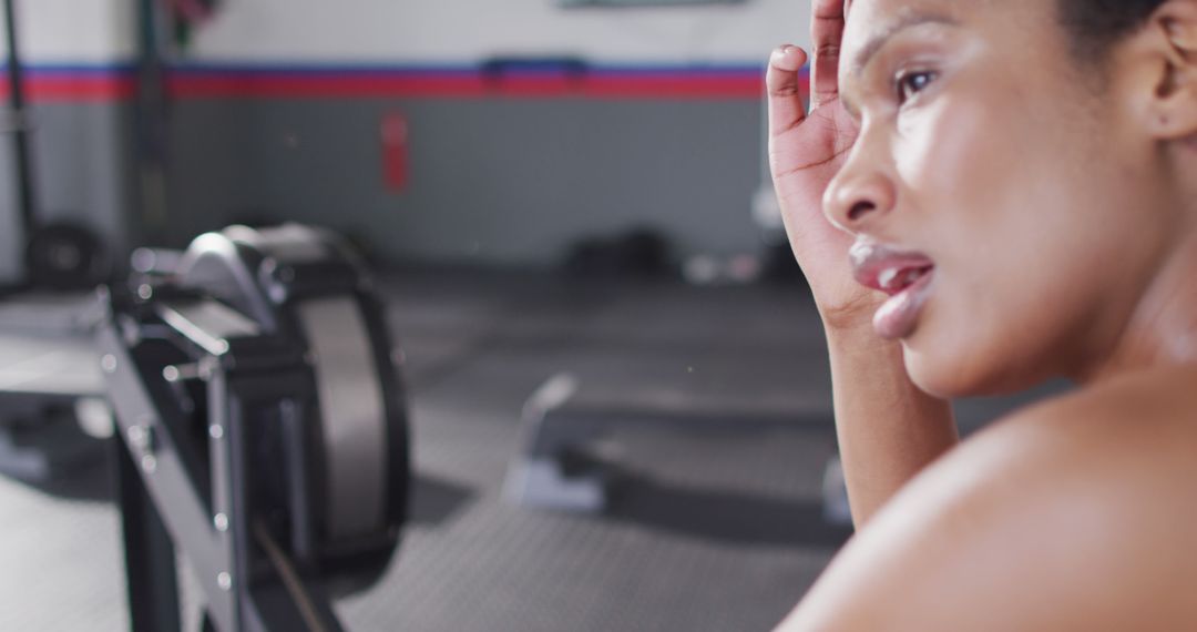 Exhausted Woman Exercising in Gym Wiping Sweat - Free Images, Stock Photos and Pictures on Pikwizard.com