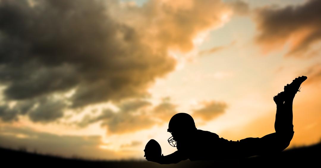Silhouette of American Football Player Diving at Sunset - Free Images, Stock Photos and Pictures on Pikwizard.com