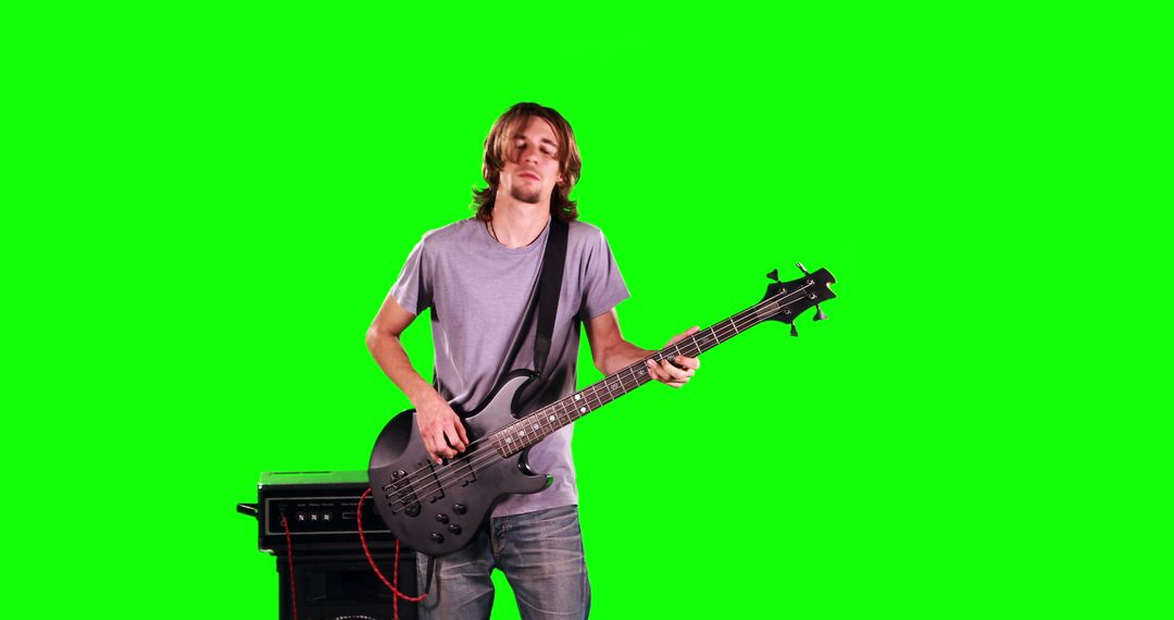 Young Man Playing Electric Bass Guitar with Amplifier on Green Screen - Free Images, Stock Photos and Pictures on Pikwizard.com