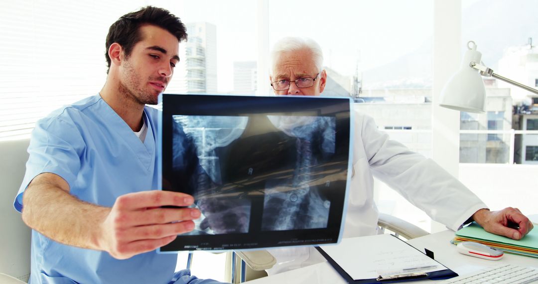 Doctors Examining Patient X-ray in Modern Clinic - Free Images, Stock Photos and Pictures on Pikwizard.com