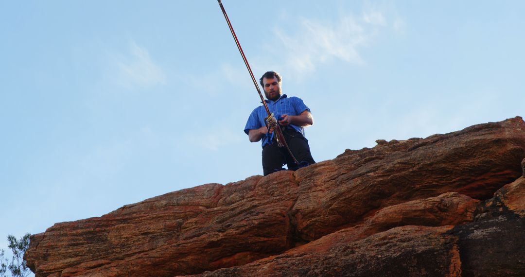 Man Preparing for Rock Climbing at Sunset - Free Images, Stock Photos and Pictures on Pikwizard.com