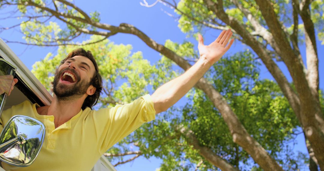 Man Enjoying Road Trip With Outstretched Arm in Forest - Free Images, Stock Photos and Pictures on Pikwizard.com