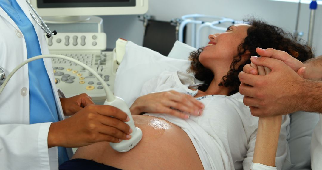 Pregnant Woman Receiving Ultrasound with Partner's Support in Clinical Setting - Free Images, Stock Photos and Pictures on Pikwizard.com