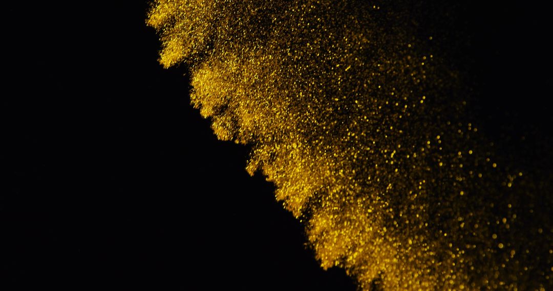 Golden glitter particles sparkle against black background - Free Images, Stock Photos and Pictures on Pikwizard.com