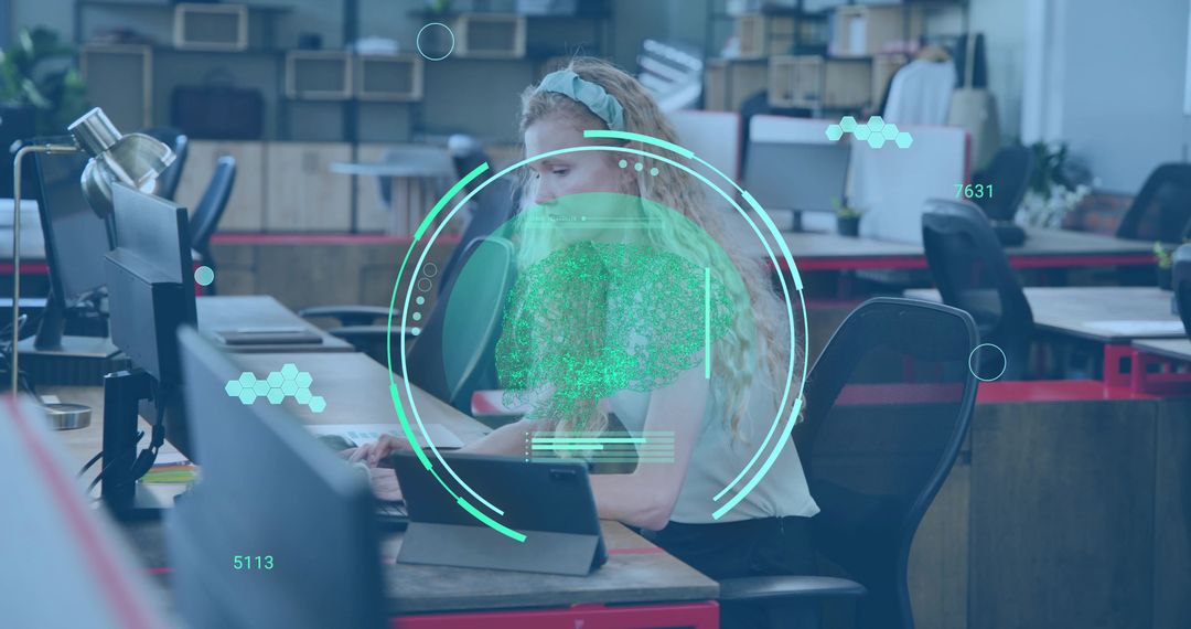 Young woman working in coworking space using tablet and monitors with AR data HUD overlay