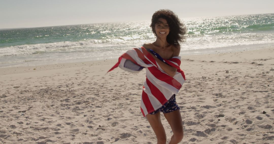 Carefree Woman Enjoying Beach with American Flag - Free Images, Stock Photos and Pictures on Pikwizard.com