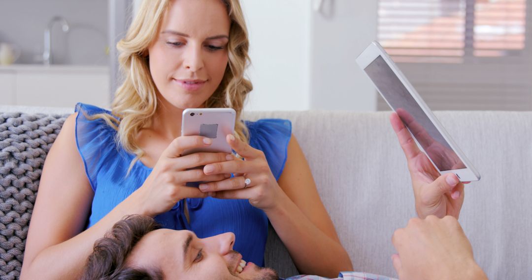 Couple Relaxing at Home with Smartphones and Tablet
