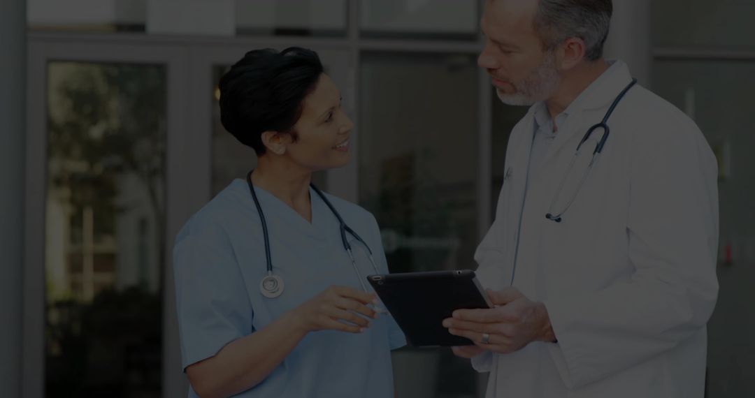 Doctors Discussing Patient Care with Tablet Technology