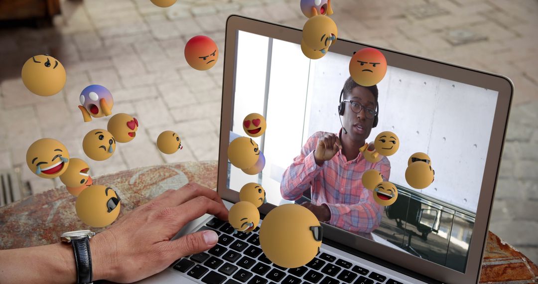 Virtual Meeting with Emotive Floating Emojis on Laptop Screen