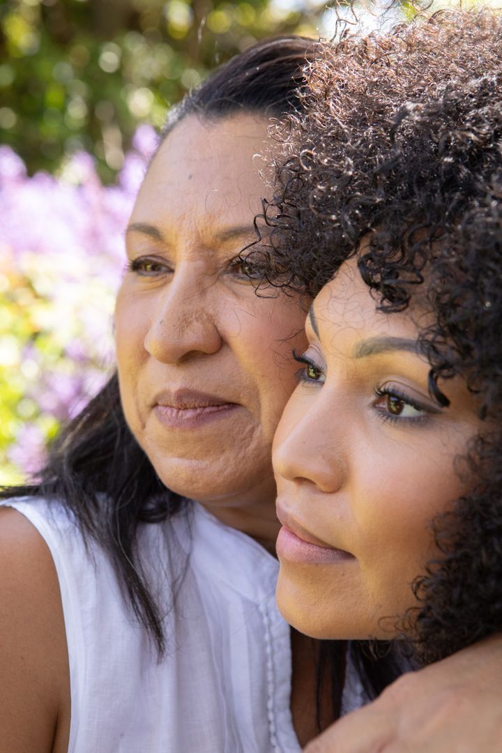 Mother and Daughter Embracing in Blooming Garden