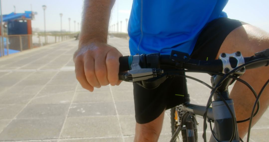 Active Senior Checking Time on Smartwatch While Biking on Promenade