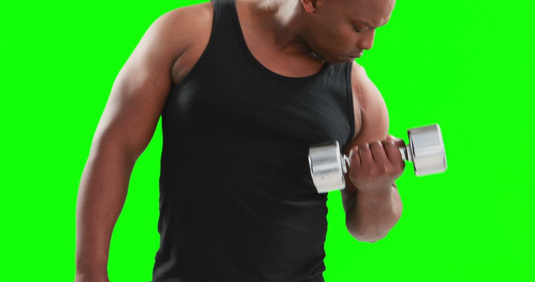 Muscular Black Man Lifting Dumbbell with Green Background - Free Images, Stock Photos and Pictures on Pikwizard.com