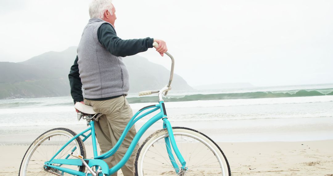 Elderly Man Enjoying Beachside View with Bicycle - Free Images, Stock Photos and Pictures on Pikwizard.com