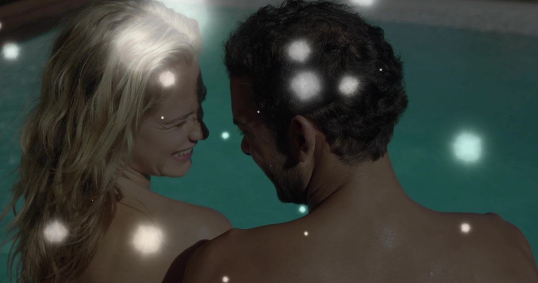Smiling Couple Gazing Poolside with Ethereal Nighttime Glows